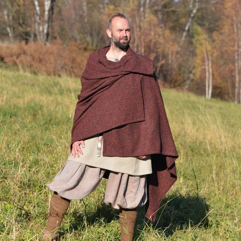 Cape made of wool in a herring bone pattern with alternating dark red, dark brown, black colors