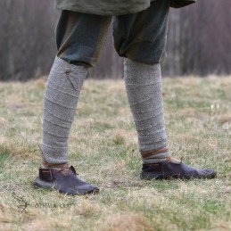 A pair of leg wraps, made from wool in a diamond pattern. Natural shades of sheep's wool were used for the weaving.