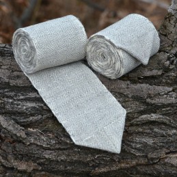 A pair of leg wraps, made from wool in a diamond pattern. Natural shades of sheep's wool were used for the weaving.