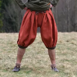 Trousers made of linen with a beige herringbone weave. Shape based on find from Haithabu, short tided under the knee.