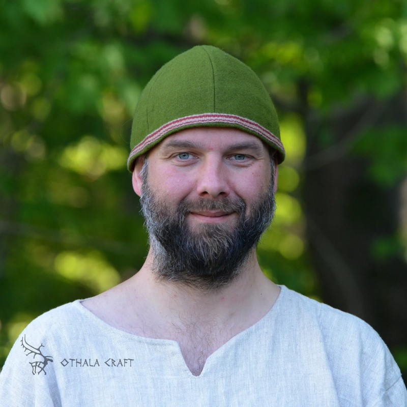 Simple hat made of green wool in diagonal pattern. Hat has six wedges.
