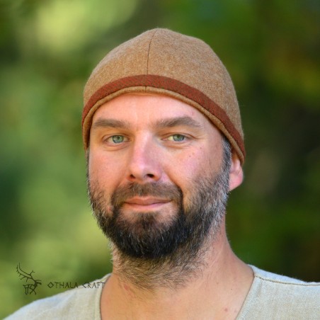 Simple hat made of beige wool, bordered with green and orange herringbone wool.