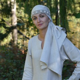 Viking Age women's headband of natural linen with sewn-on cowrie shells.