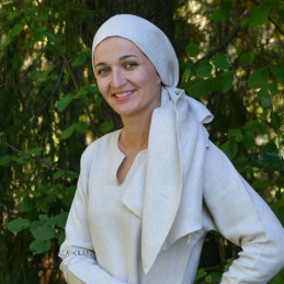 Viking age women's linen headscarf in natural linen shades, tied as a head covering.